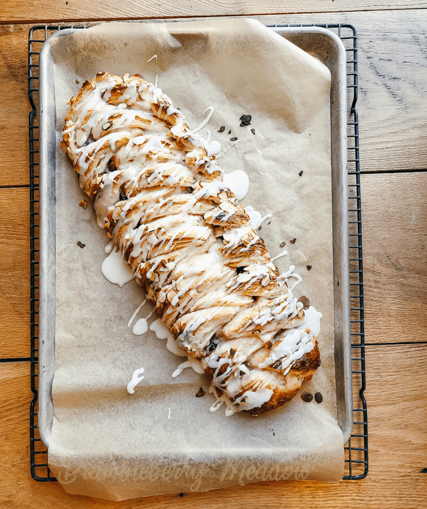 Frosted kringle on baking sheet